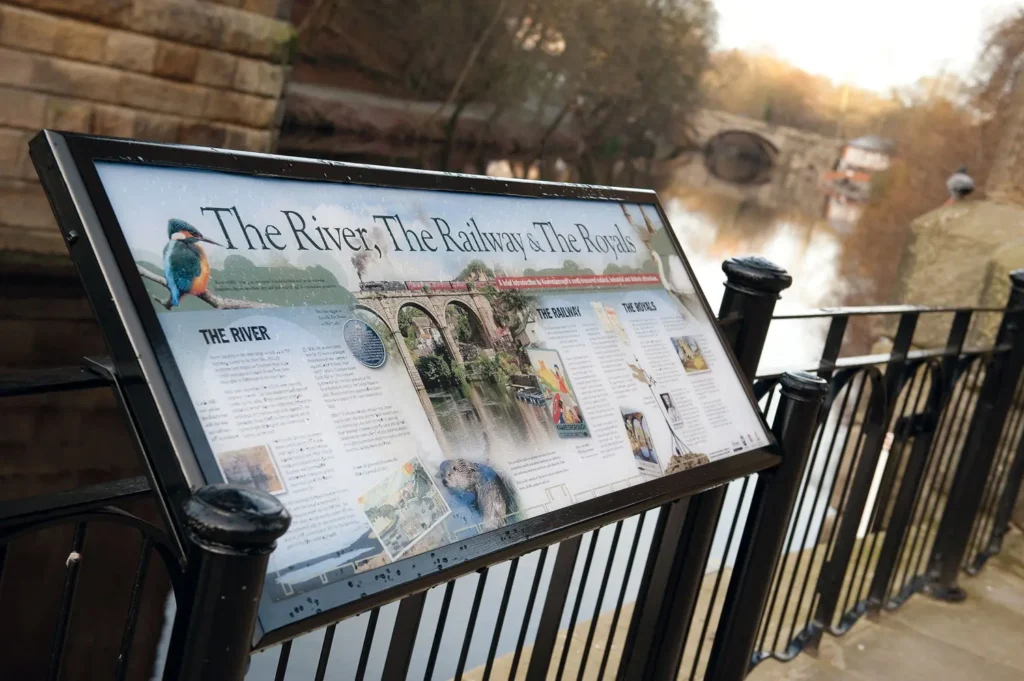 Knaresborough interpretation panel mounted on railings alongside the river Nidd